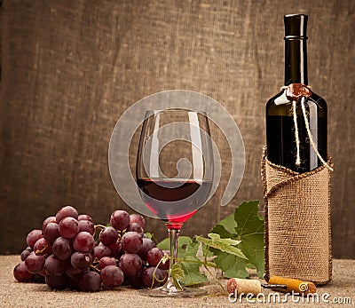 Still life with wine bottles, glasses and grapes Stock Photo