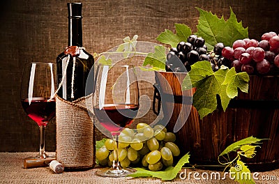 Still life with wine bottles, glasses and grapes Stock Photo
