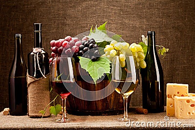 Still life with wine bottles, glasses and grapes Stock Photo