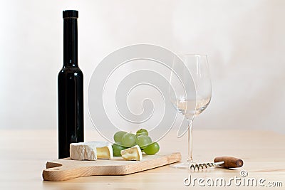 Still life with wine glass, bottle and cheese Stock Photo