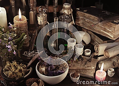 Still life with witch books, scrolls, herbs and magic objects Stock Photo