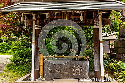 Stillness at the water basin at the entrance of a shrine in Japan for the riual Temizuya purification - 12 Stock Photo