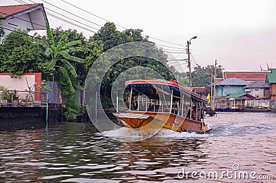 Stilt houses at a klong in Bangkok. Klongs are the canals, that branch off from Chao Phraya river, the big river of Bangkok. The Editorial Stock Photo