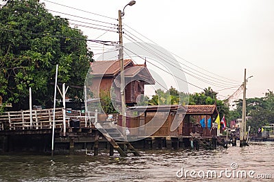 Stilt houses at a klong in Bangkok. Klongs are the canals, that branch off from Chao Phraya river, the big river of Bangkok. The Stock Photo