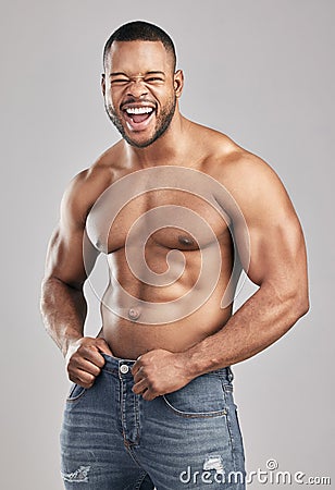 Stimulate dont annihilate. Studio shot of a young muscular man posing against a grey background. Stock Photo
