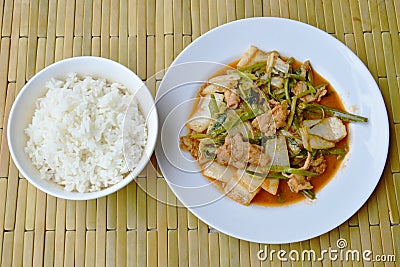 Stir fried mixed vegetable and pork in sukiyaki sauce eat with plain rice Stock Photo