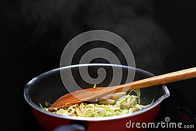 Stir Fried Mixed Vegetable in teflon pan heat source by induction cooker Stock Photo