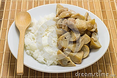 Stir fried mushrooms with pork on wooden background,Thai food Stock Photo
