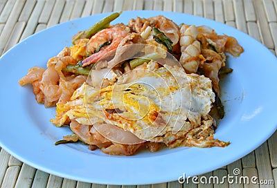 Stir fried rice noodle seafood and egg with sukiyaki sauce on dish Stock Photo