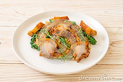 Stir-fried rice vermicelli and water mimosa with crispy pork belly Stock Photo