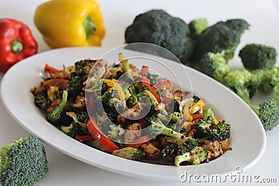 Stir fried vegetables with chicken. Air fried chicken cubes tossed with sauteed bell peppers and broccoli Stock Photo