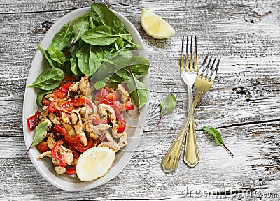 Stir fry of chicken breast and sweet red pepper and fresh spinach Stock Photo