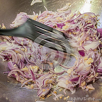 Stir-frying chopped onions, shallots and garlic in a wok. Stock Photo