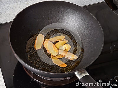 Stir-frying Ginger at high heat to bring forth the savory aroma with sesame oil Stock Photo