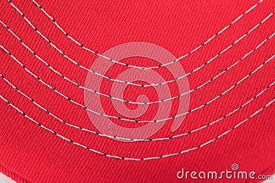 Stitching of white thread on a read cloth or material Stock Photo