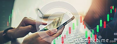 Stock exchange market concept, hand using smartphone with graphs analysis candle line on bokeh colors light Stock Photo