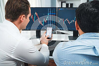 Stock exchange traders pointing lowest chart stage on dynamic graph. Sellable. Stock Photo
