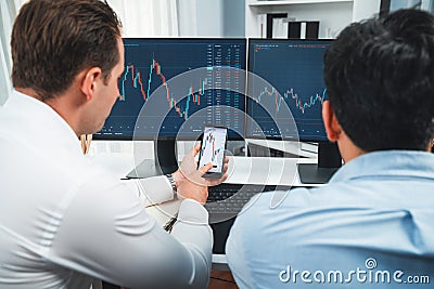 Stock exchange traders pointing lowest chart stage on dynamic graph. Sellable. Stock Photo