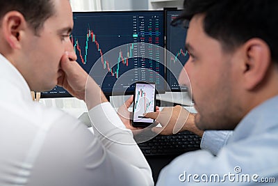 Stock exchange traders pointing lowest chart stage on dynamic graph. Sellable. Stock Photo