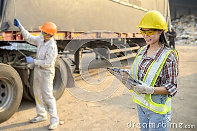 Stock keeper girl Controlling young male worker to prepare products before sending out for sale Stock Photo