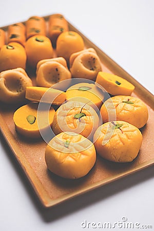 Stock photo of collection of variety of sweets or orange peda or pedha or pera made up of milk, khoya, sugar , saffron etc. select Stock Photo