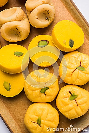 Stock photo of collection of variety of sweets or orange peda or pedha or pera made up of milk, khoya, sugar , saffron etc. select Stock Photo