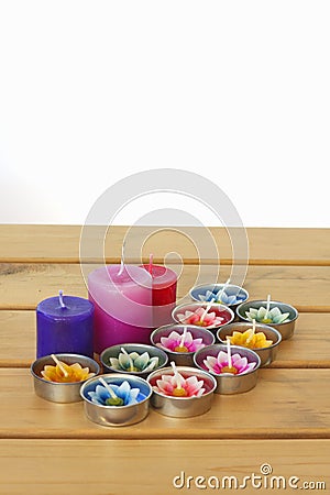 Stock Photo:Colorful candles on wooden tablt with white backgro Stock Photo