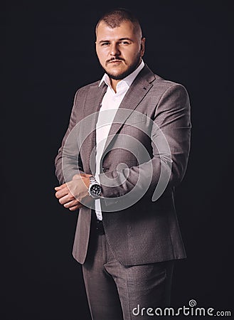 Stock Photo - Confident young man posing at camera in suit Stock Photo