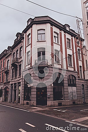 Classic Corner Building in Dinant, Belgium with Retail Storefront Stock Photo