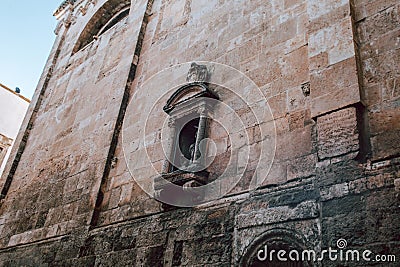 Historic Building in Ostuni featuring a Prominent Religious Statue Stock Photo