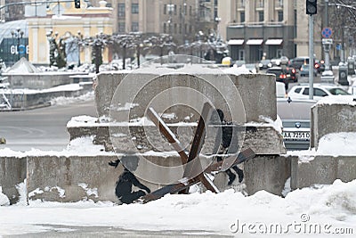 A boy and a girl swing on an anti-tank hedgehog - Banksy graffiti in Kyiv, Ukraine Editorial Stock Photo