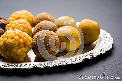 Stock photo of collection of variety of sweets or orange peda or pedha or pera made up of milk, khoya, sugar , saffron etc. select Stock Photo