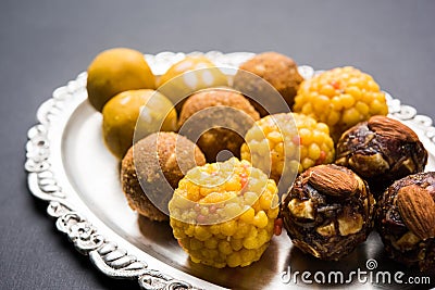 Stock photo of collection of variety of sweets or orange peda or pedha or pera made up of milk, khoya, sugar , saffron etc. select Stock Photo