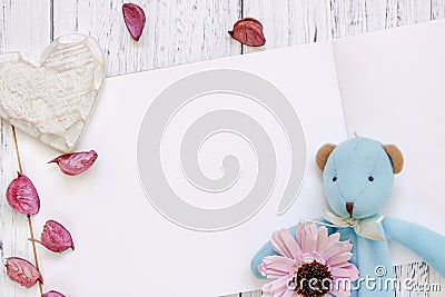 Stock Photography flat lay vintage white painted wood table purple flower petals bear doll heart craft Stock Photo