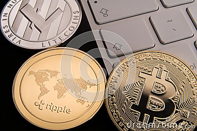 Stock of physical bitcoins, btc, bitcoin, ripple, ethereum, litecoins, gold and silver coins, cryptocurrency concept Editorial Stock Photo