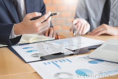 Stock traders looking at finance analysis marketing report trading stocks online in office Stock Photo