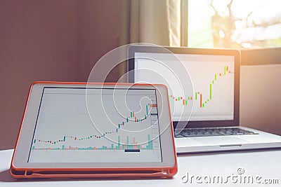 Stock trading forex on tablet and laptop on a white table Stock Photo