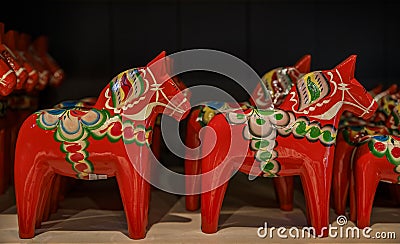 Traditional hand-made carved and painted dalarna wooden horse souvenir at a souvenir shop in Stockholm, Sweden Editorial Stock Photo
