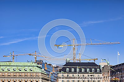 Stockholm Sweden, Cranes Working above Rooftops Editorial Stock Photo