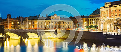 Stockholm Sweden. View Of Norrbro, Old Stone Arch Bridge Over Norrstrom Waterway With Lights Reflections In The Water Editorial Stock Photo