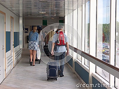 Stockholm, Sweden - July, 2007: tourists with suitcases crowded at the exit in the Swedish port Editorial Stock Photo