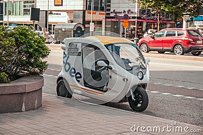 Stockholm, Sweden - June 7, 2019: White three wheeler commercial vehicle in the road. Rental motorbikes on parking Editorial Stock Photo