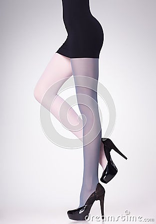 Stockings on woman legs on grey Stock Photo