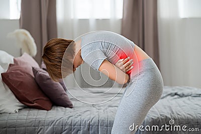 Stomach ache, symptoms of gastritis or pancreatitis, woman with abdominal pain suffering at home Stock Photo