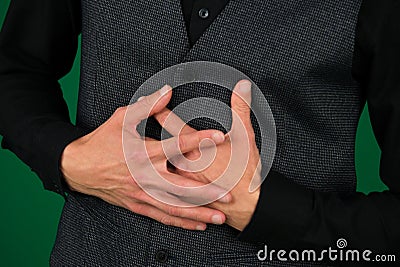 Stomach pain, stomach muscles injury, male abdomen abs muscle upset stomach worries hold hands on stomach suit close-up Stock Photo