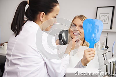 Stomatologist checking the woman`s teeth during dental checkup Stock Photo