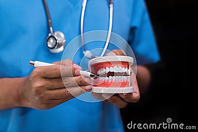 Stomatologist gives recommendations and shows the patient the procedure for dental treatment. Stock Photo