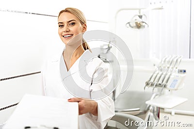 Stomatologist giving blank to her client in office Stock Photo