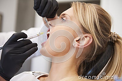 Stomatologist giving woman anesthesia in dentist`s clinic Stock Photo