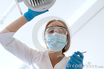 Stomatologist in mask and gloves preparing for patients teeth treatment Stock Photo